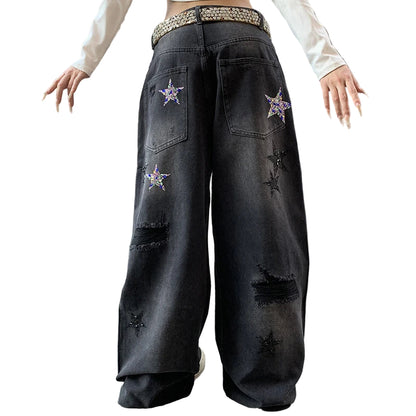 Person wearing black distressed jeans with star patterns.