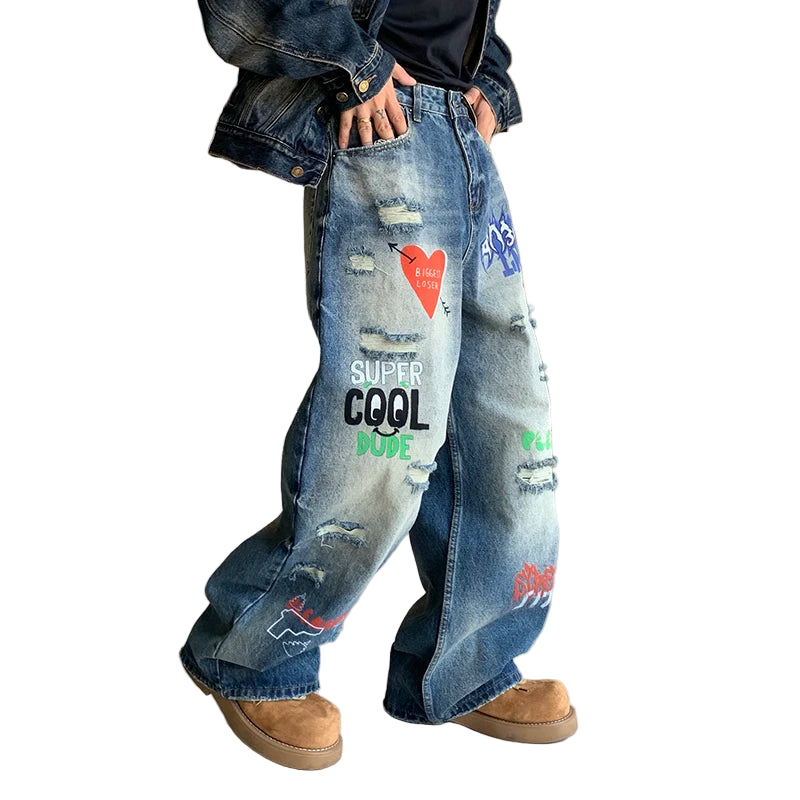 Person wearing blue jeans with text and graphics, standing indoors.