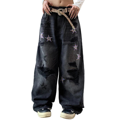 Person wearing black distressed jeans with star patterns.